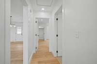 Hallway just off breakfast area leading to bedroom 2 & 3 with hall bath