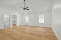 Primary Bedroom with raised ceilings, recessed lighting, double windows, large walk in closet and bathroom.