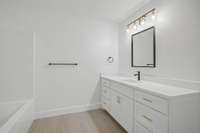 Hall Bathroom features oversized vanity, quartz countertop, linen closet and toilet room.