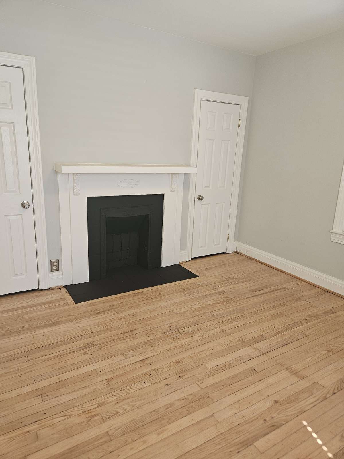 Bedroom #3 with resurfaced floors and decorative fireplace