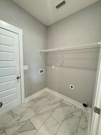 Laundry room with door that leads out to 2 car garage.

*Photo is from a previous listing displaying the completed floor plan some options and selections may vary from actual home.