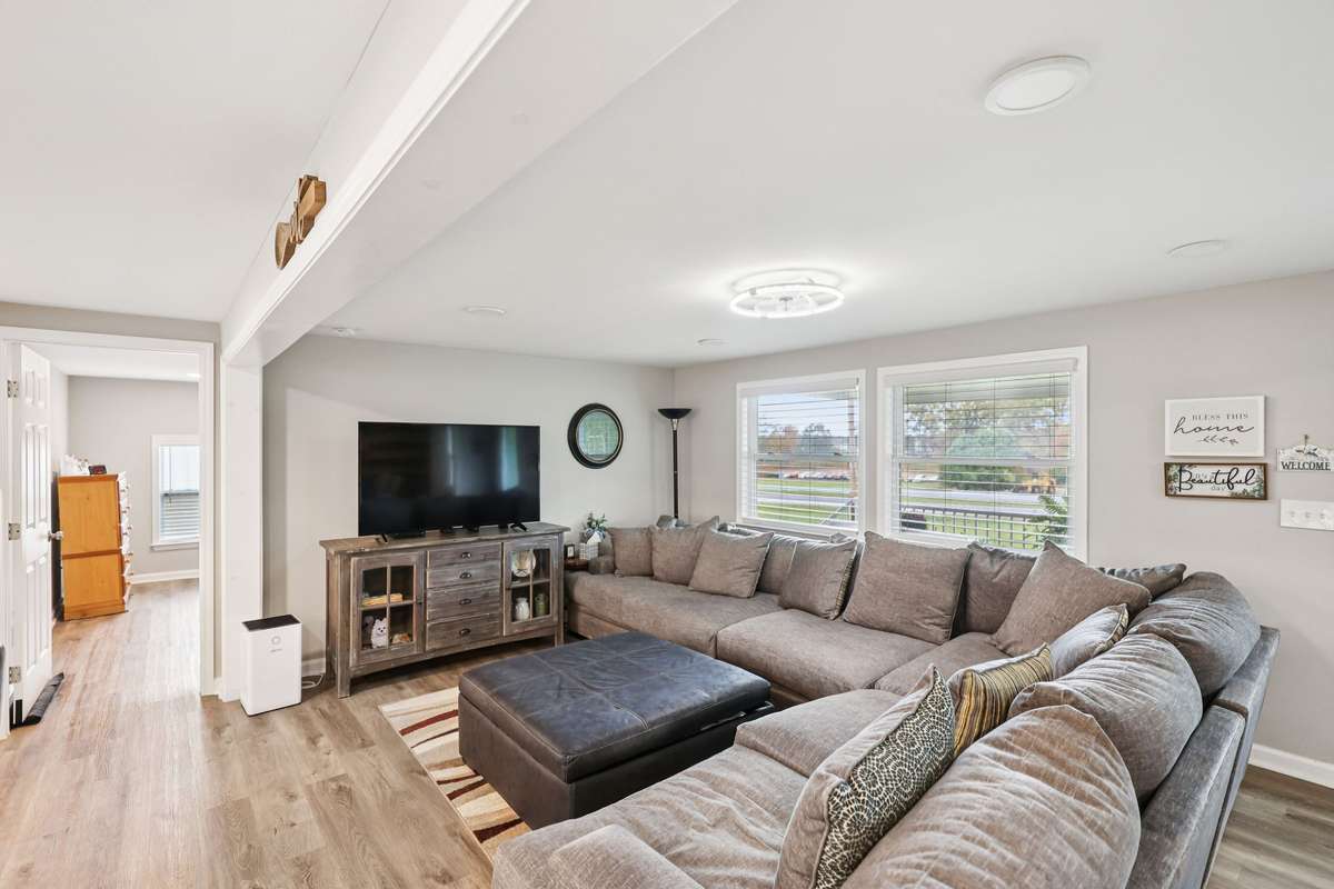 Living room offers a modern over head light fixture and two large windows.   4775 New Tullahoma Hwy Manchester TN 37355