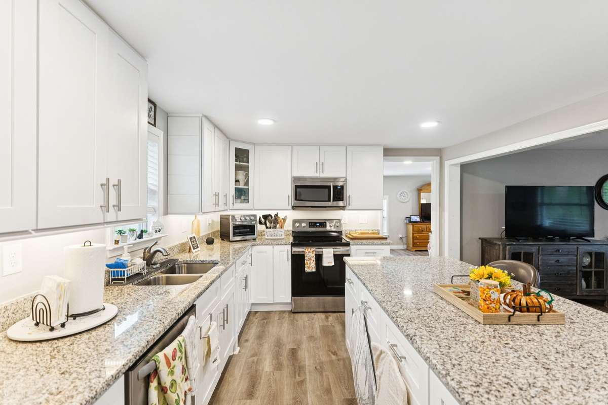 Kitchen has crisp white cabinets and stainless steel appliances.  4775 New Tullahoma Hwy Manchester TN 37355