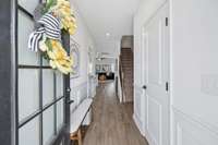 Foyer with half bath on righthand side.