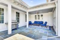 Covered sitting area off pool and recreation room