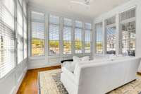 Primary bedroom sitting room overlooking the farm from all windows