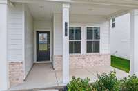 This beautiful front porch is perfect to get your guests out of the rain, as well as sitting and relaxing with a glass of your favorite beverage.