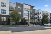 Front of building with street parking.