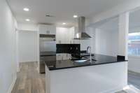 Just beautiful! The primary bedroom is in the front of the house, just off the living room. The additional 2 bedrooms, extra bathroom and laundry room are through the hallway beyond the kitchen.