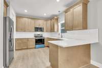 Kitchen boasts Quartz countertops and stainless appliances