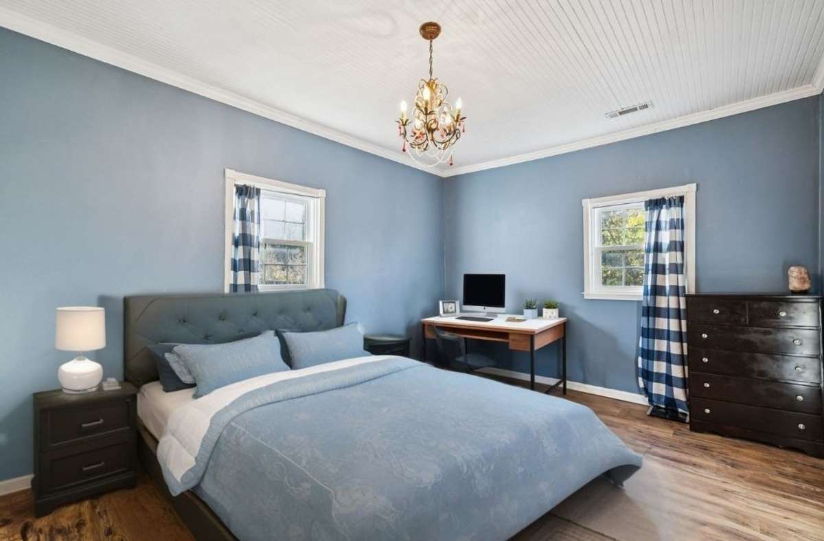 Second bedroom offers hanging chandelier, windows, and lots of space.   3007 Fullerton Ln College Grove Tn 37046