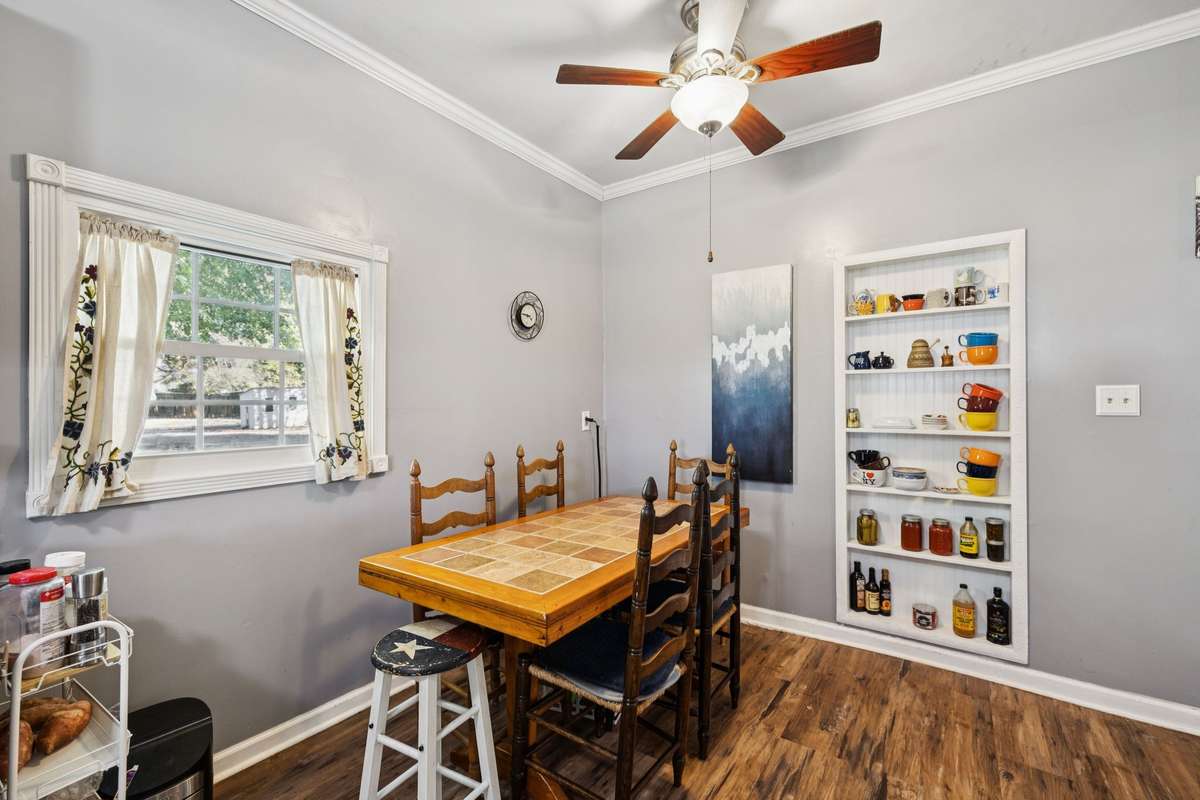 Dinning area offers built-in shelves, a window, and a ceiling fan.  3007 Fullerton Ln College Grove Tn 37046