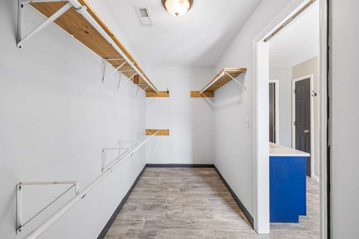 Primary bedroom walk in closet off of the bathroom.