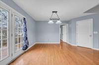 The dining area has hardwood flooring and enhanced by a French door that leads to the back deck.