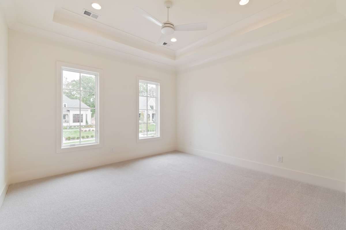 One of three secondary bedrooms upstairs. All bedrooms are ensuite and have generously-sized walk-in closets.