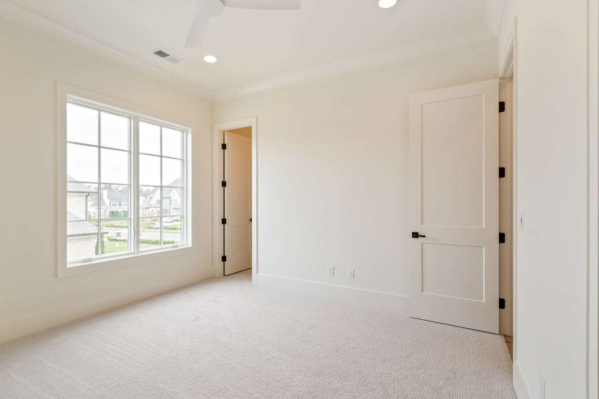 One of three secondary bedrooms upstairs. All bedrooms are ensuite and have generously-sized walk-in closets.