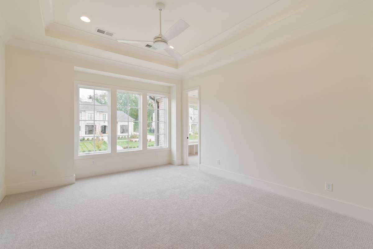 One of three secondary bedrooms upstairs. All bedrooms are ensuite and have generously-sized walk-in closets.