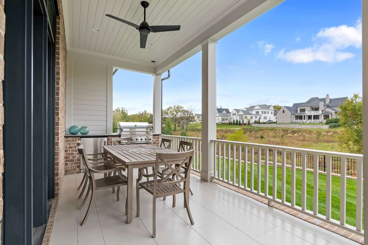 Enjoy all-year-round on the covered back porch located right off of the Great Room on the main level. Also includes Grill station, as pictured here!