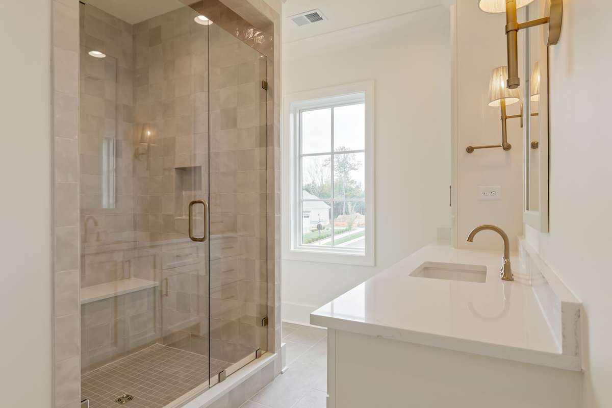 One of three secondary bathrooms upstairs. All bedrooms are ensuite and have generously-sized walk-in closets.