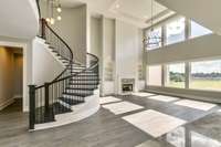 Experience the wow factor in this grand two-story great room, where floor-to-ceiling windows flood the space with natural light