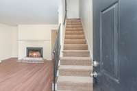 Wood burning fireplace, new LVP flooring and new carpet on stairs.
