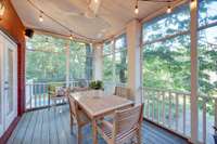 The screened in and covered back porch is perfect for outdoor dining under the party lights.