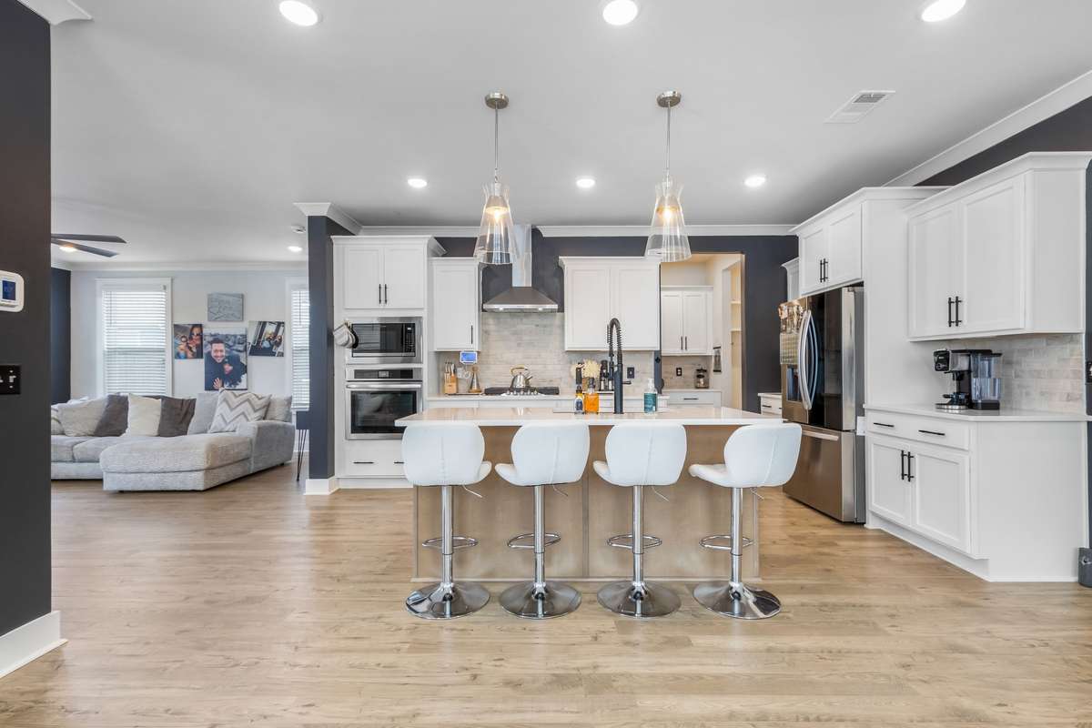 Chef's dream kitchen complete with gas cooktop, large prep island and butlers pantry in the distance.