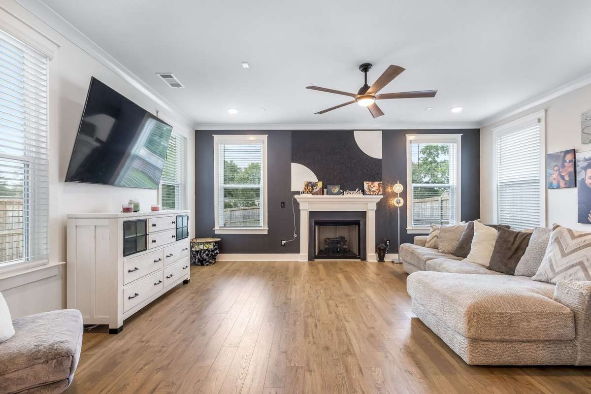 Super spacious living room offers tons of natural lighting and a cozy fireplace