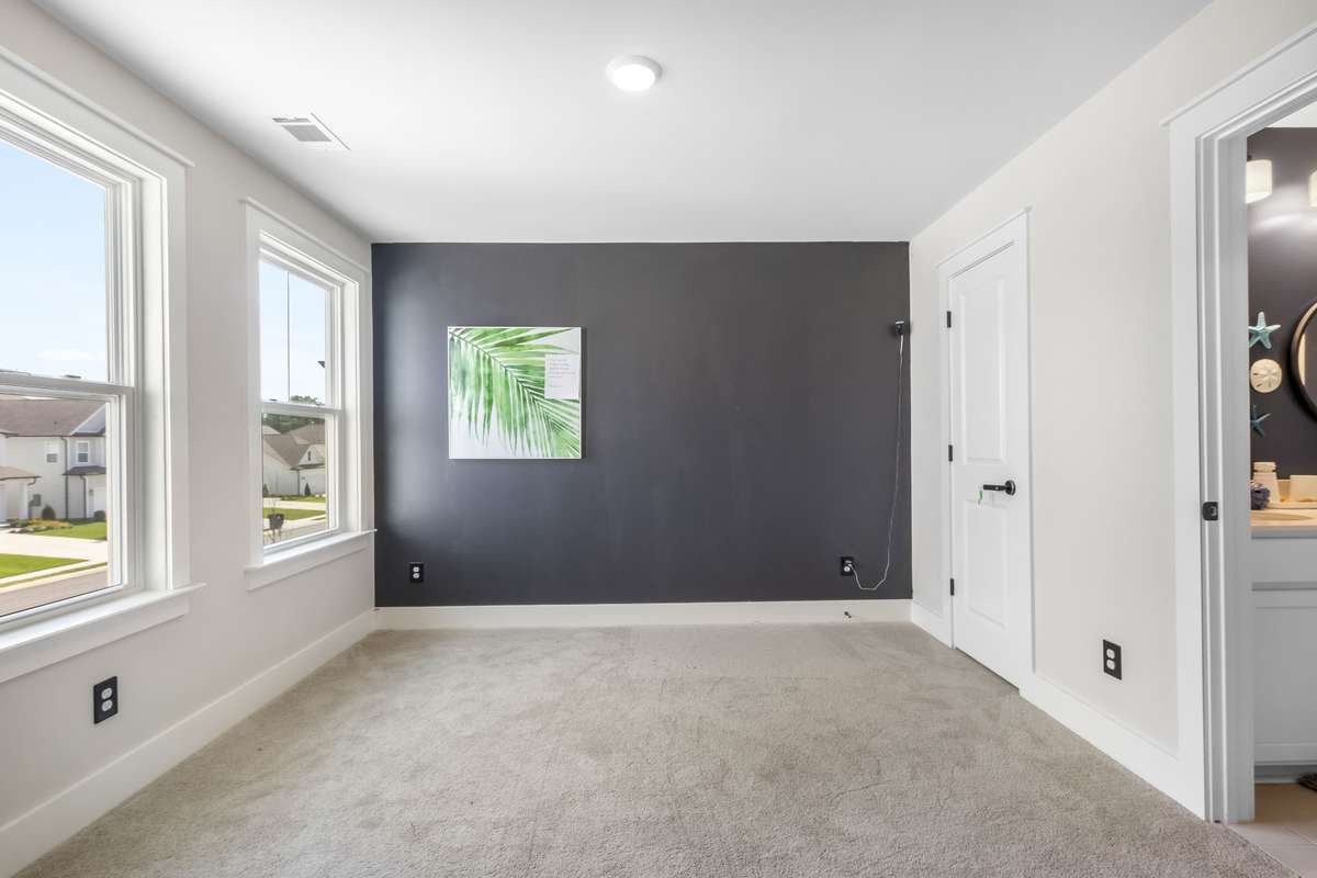 The third bedroom offers walk in closet, double windows and access to the bathroom. This bedroom is located on the front of the house.