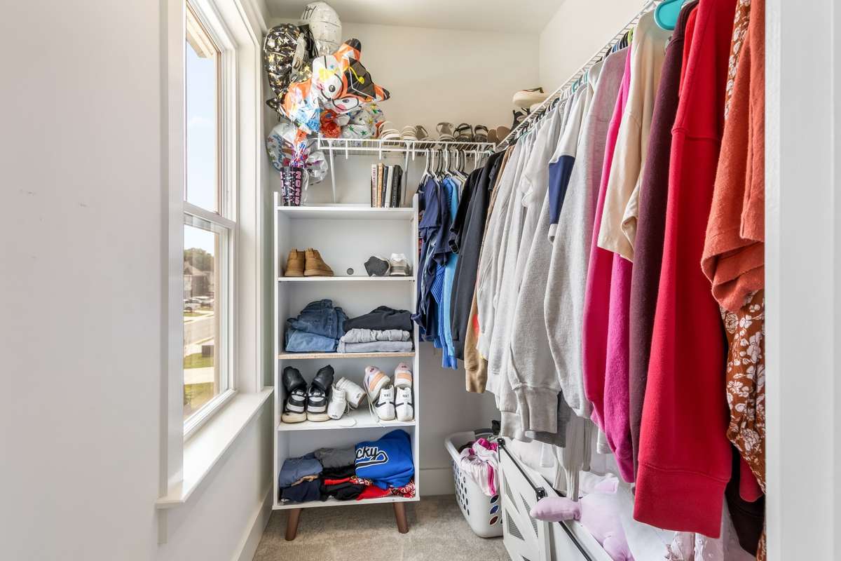 Walk in closet offered in that same bedroom... complete with a window for natural lighting.