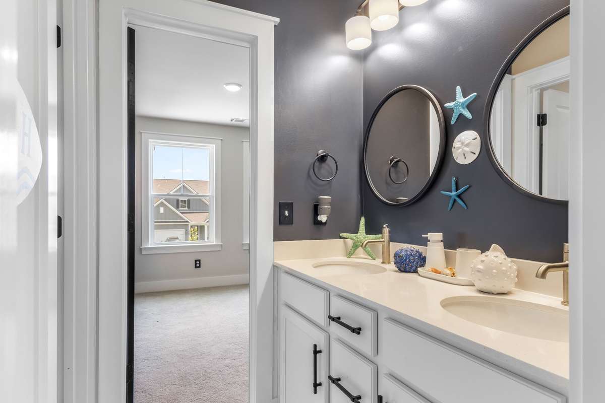 Yes there is a Double vanity in the secondary bathroom. This bathroom is located between the two bedrooms that border the loft area.