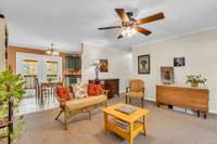 The inviting living area is designed for conversation, comfort, and connection.  Notice how it's open directly to the dining area and kitchen.