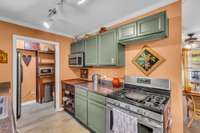 The country green cabinets are both functional and charming.