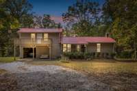 Golden-hour sunset over the hills paints the property in warm Tennessee light. **AI enhanced sunset picuture