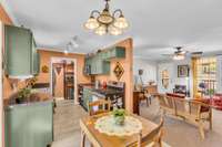 Directly adjacent to the dining area, the thoughtfully updated kitchen with ample cabinetry, modern finishes, and an inviting farmhouse feel.