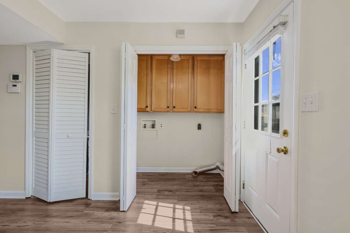 Additional storage in the laundry area with tall cabinets.