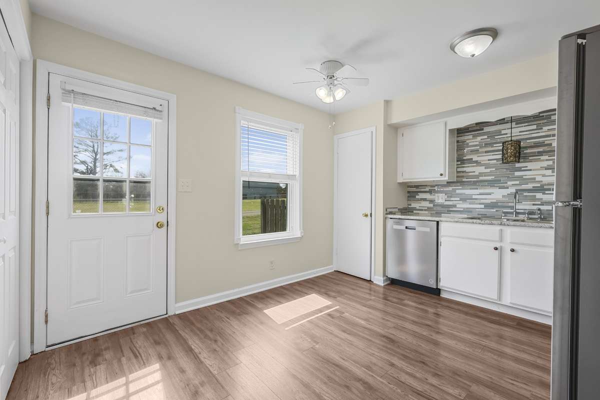 A small table would fit perfectly again the wall with the window.