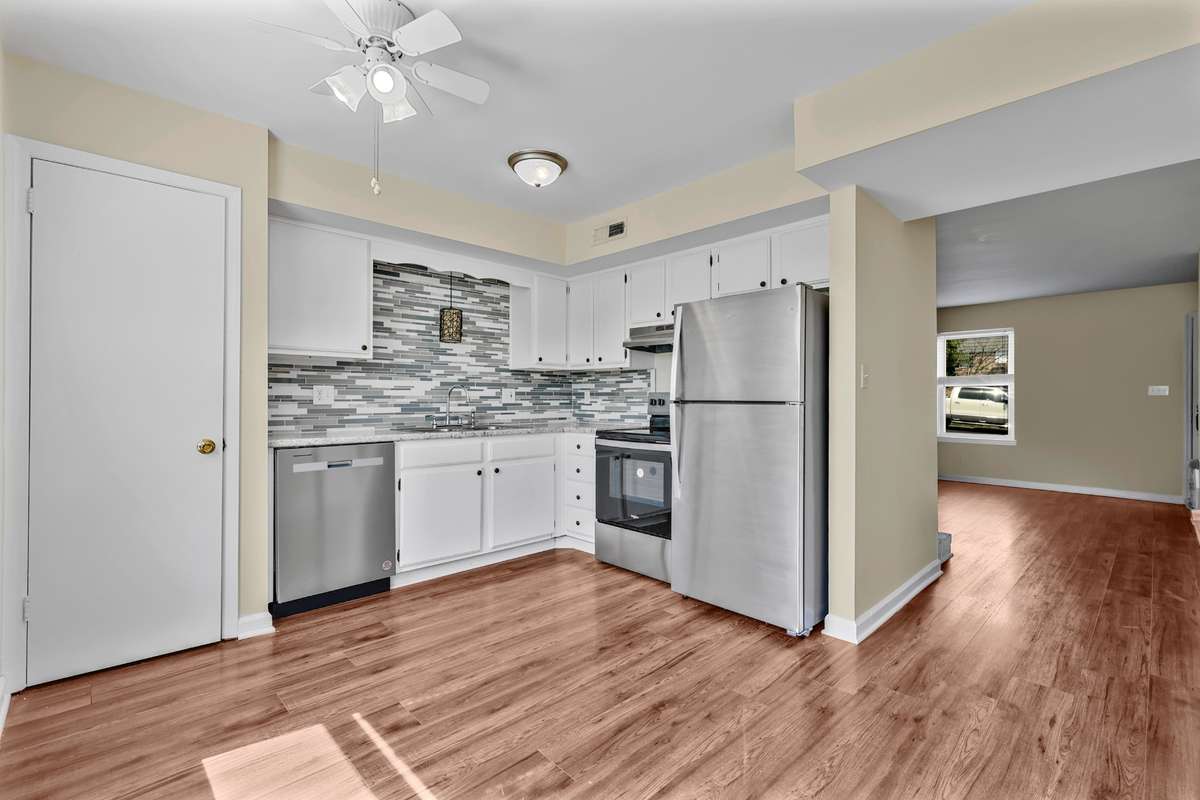 Kitchen features stainless steel appliances and easy access to the rest of the main living area.
