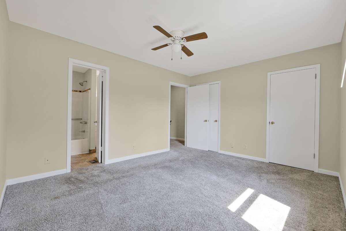 This bedroom offers direct access to the shared bath, adding extra convenience and functionality.