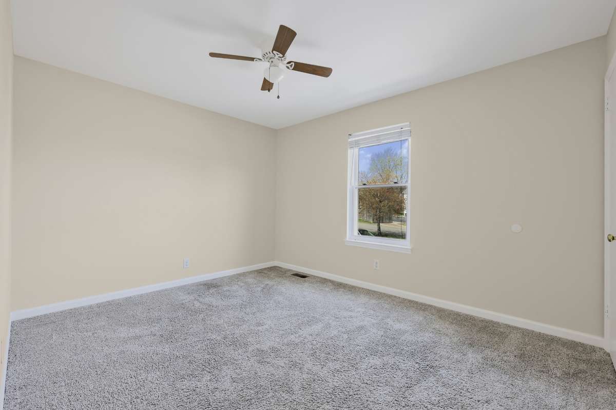 Bedroom features ceiling fan lighting and window blinds for comfort and privacy.