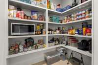 *SLIDING BARN DOOR LEADS INTO THE WALK-IN PANTRY WITH BUILT-IN SHELVING*