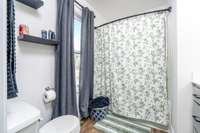 Offers a tub/shower combination & floating shelving