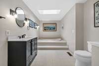Primary bathroom with massive soaker tub, shower and skylights!