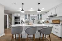Gorgeous new custom kitchen on the basement level. Quartz Counters, large island and stainless steel appliances