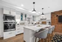 Gorgeous new custom kitchen on the basement level. Quartz Counters, large island and stainless steel appliances