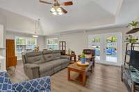 Living room and dining room have a beautiful view of an outside oasis.