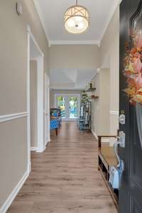 Entry way reveals high ceilings, hardwood floors, and detailed millwork.