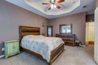 Primary bedroom is newly carpeted. En suite bathroom with separate tub and shower, walk in closet, and double vanity. There is abundant space for everyone. (Some photos have been adjusted for staging purposes.)