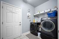 Laundry room off garage is tiled