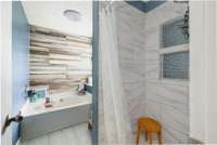 gorgeous ceramic wood look tile next to Carrera ceramic. This bathroom is your zen!